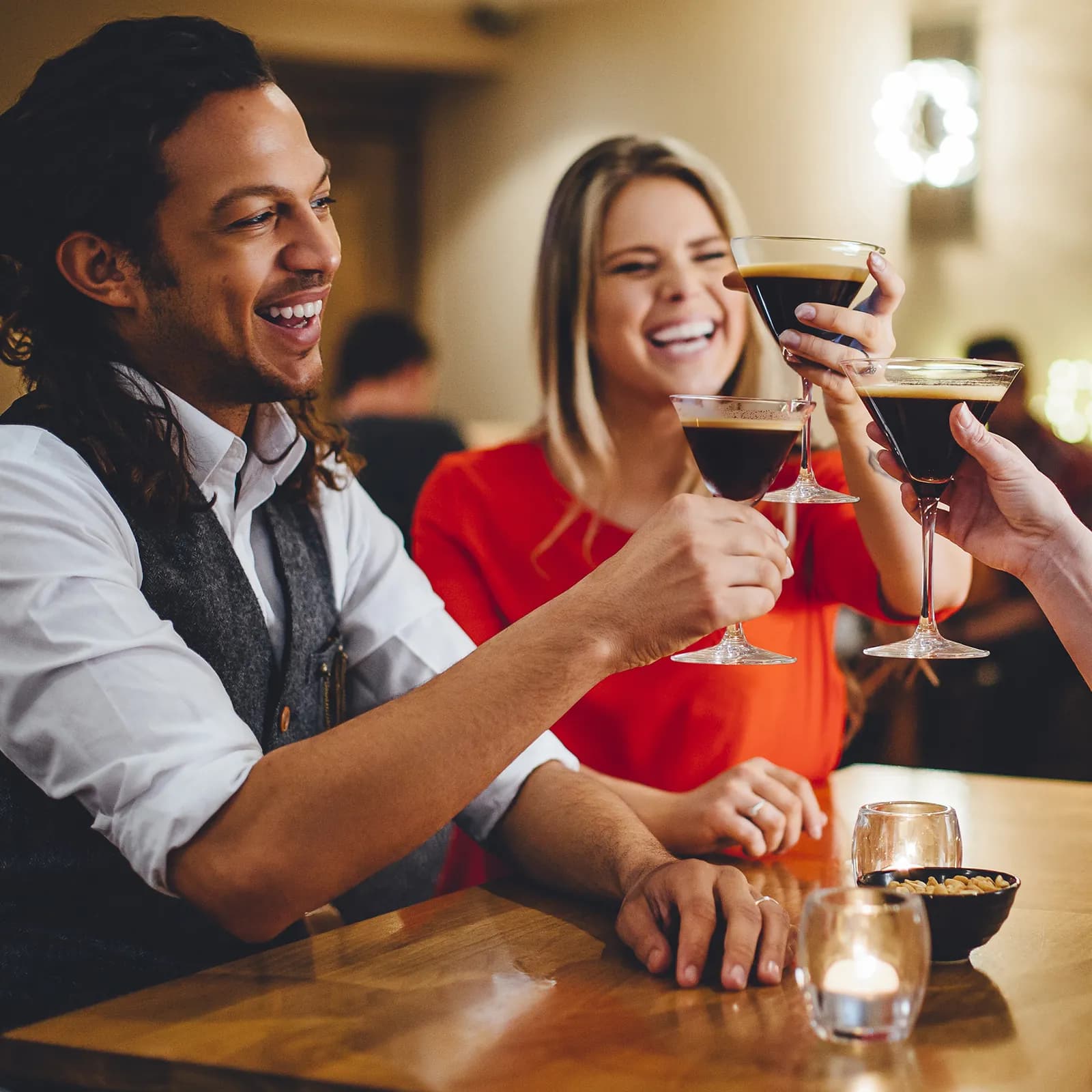Friends toasting with Spark Plug espresso martinis